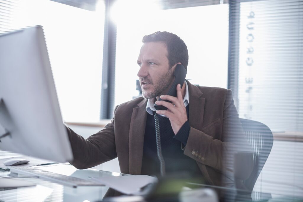 Businessman talking on phone in office
