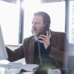 Businessman talking on phone in office