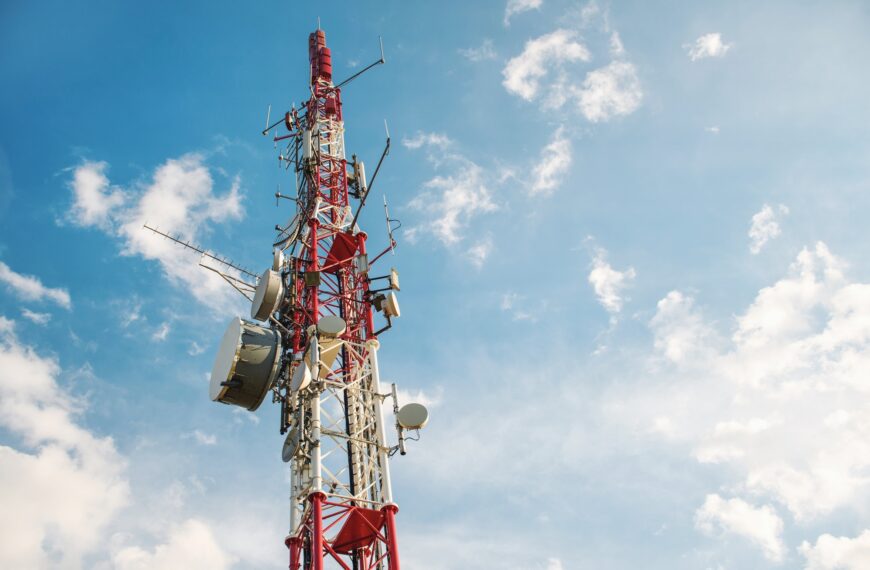 Low angle view of Antenna tower against a blue sky. 5g network cell tower.
